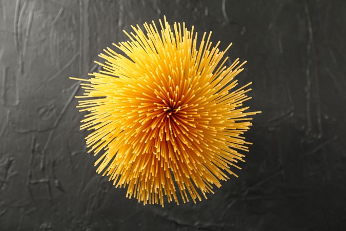 Pasta on dark background, space for text and top view