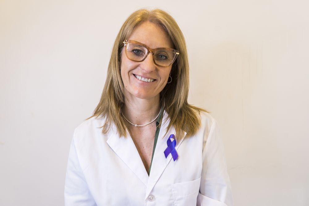 Female doctor using breast cancer awareness ribbon.