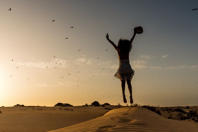 Active woman walking in dry desert barefoot
