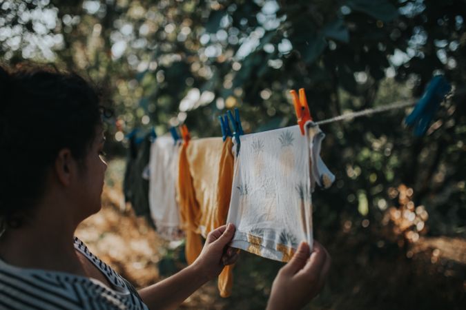 Woman hangs clothes on a clothes line