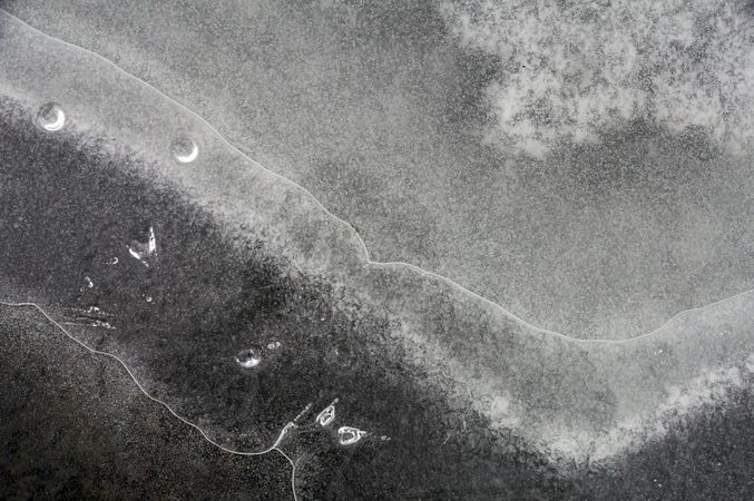 Fragment of thin ice on dark frozen river