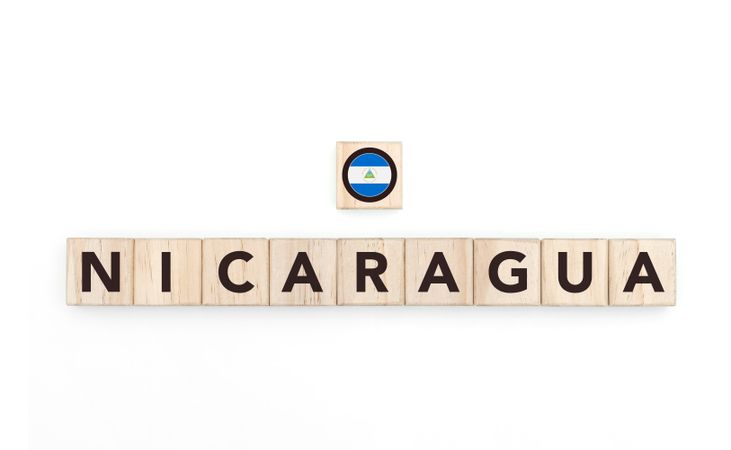 Wooden blocks bearing the name and flag of Nicaragua. Nicaraguan and Caribbean Culture, national identity, travel, and geography in a copy space design.