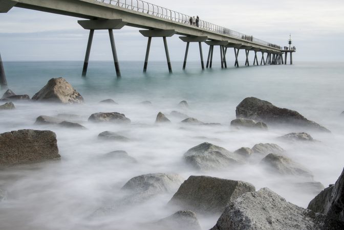 Pier on the rocky coast of Badalona, Spain