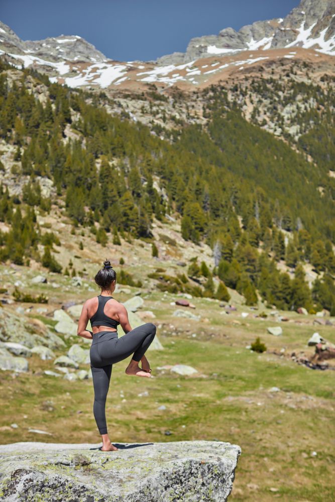 Fit young woman in mid yoga pose