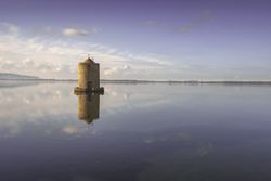 Old spanish windmill in Orbetello lagoon, Argentario, Italy