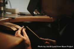Close up of a female goldsmith working and shaping an unfinished ring 4d1nEb
