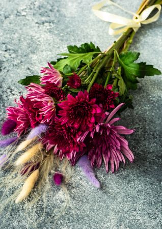 Bouquet of aster flowers on stone background with copy space