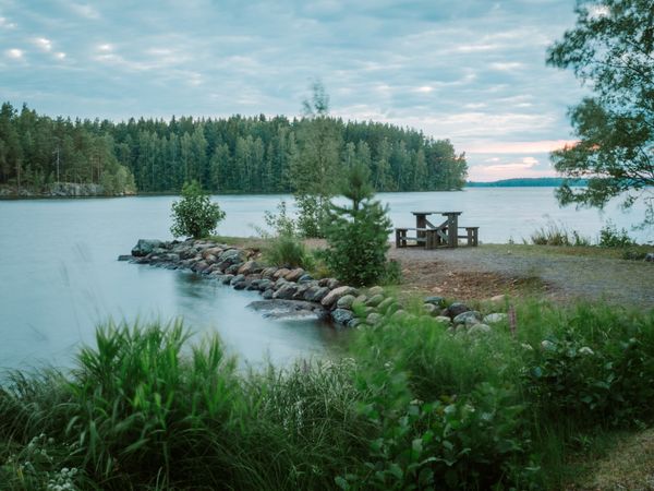 Landscape with table and benches on lakeside