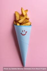 French fries in blue cone on pink background 4OpqZb