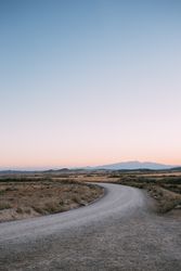 Sunset over bend in the road, portrait