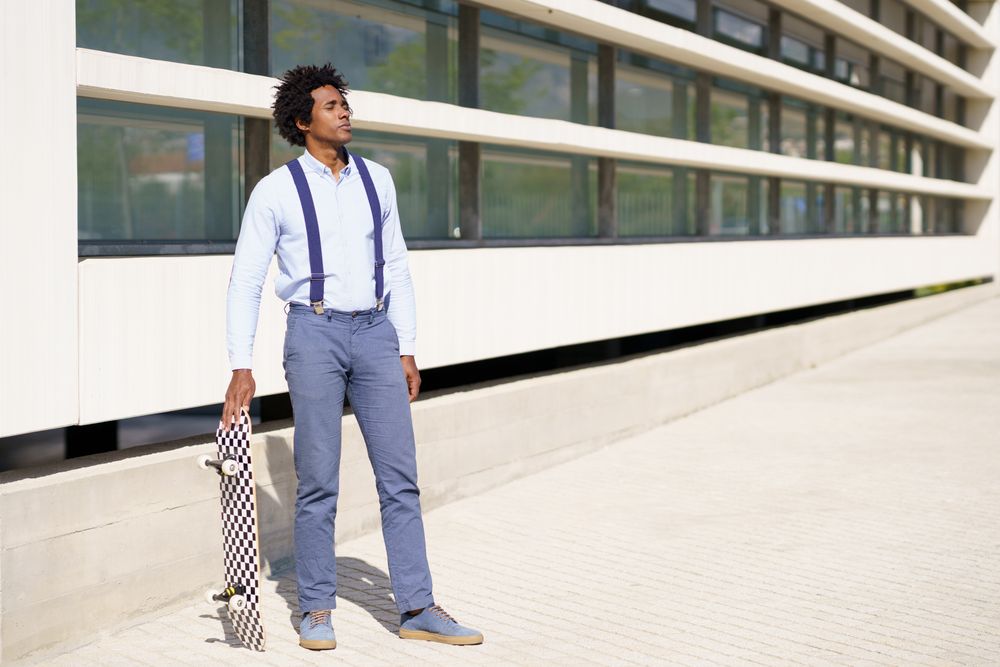 Man outside his office with skateboard