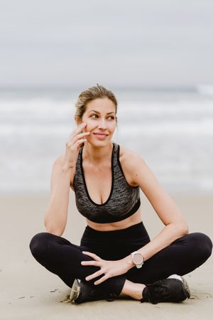 Woman meditating on the beach