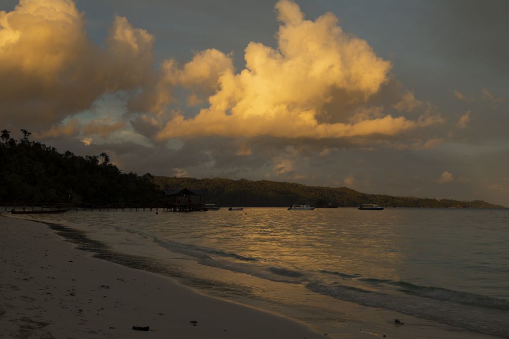 Clouds over the rainforest and one of Yenbeser beaches, Raja Ampat islands, West Papua, Indonesia