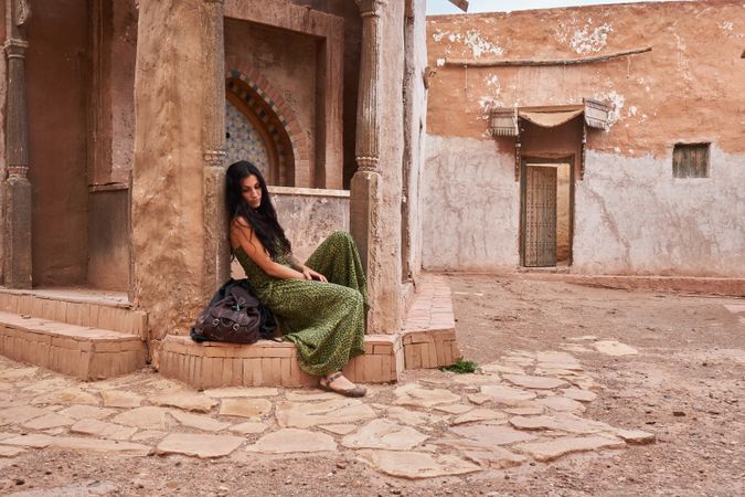 Woman on street between ancient buildings
