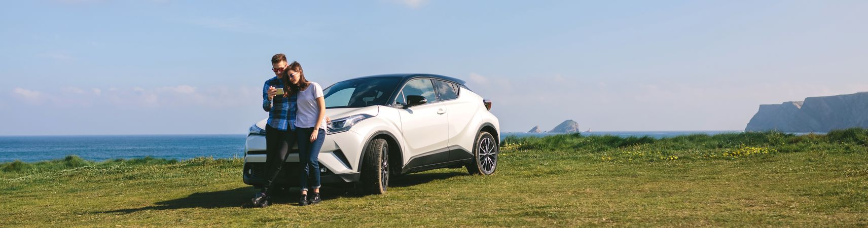 Couple with car looking mobile