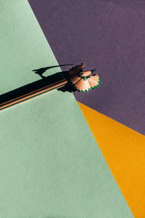 Pencil and shavings from sharpening, on colored background