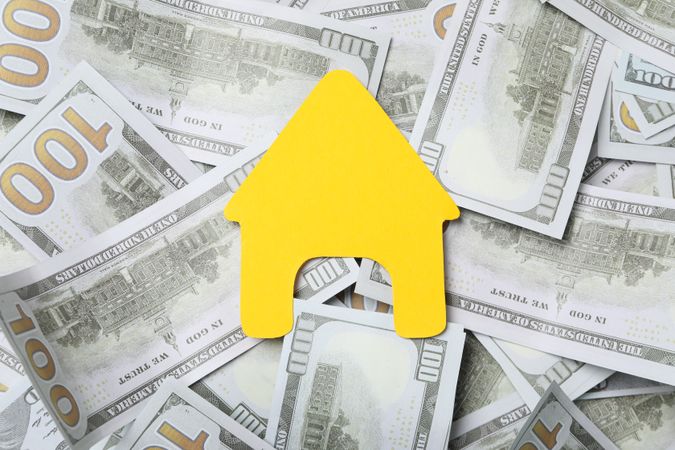 American cash money and yellow house, top view