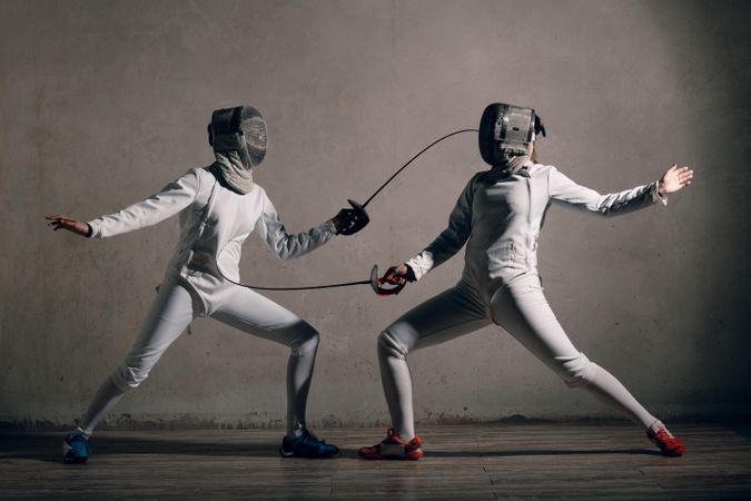 Two people playing fencing