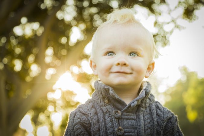 Adorable Blonde Baby Boy Outdoors at the Park.