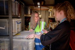 Two women working together in stock room