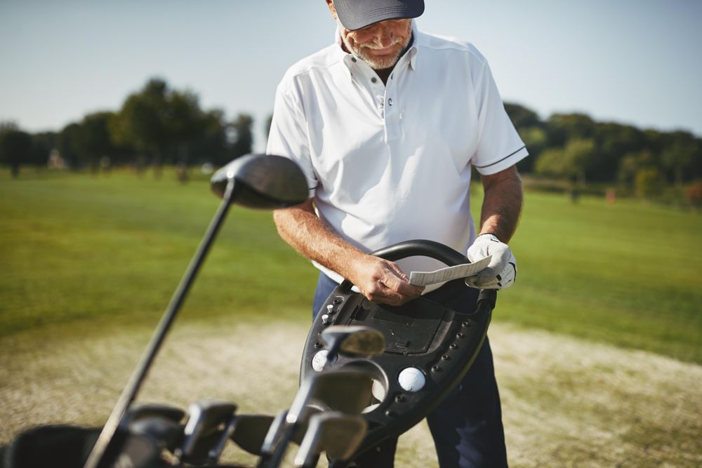 Man recording his score during a golf game