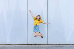 Young cheerful woman jumping