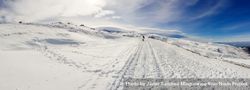 Snowboarder in distance of ski resort of Sierra Nevada in winter beVgp0