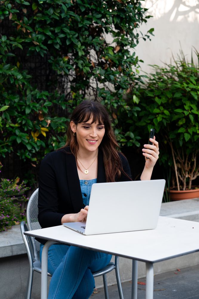 Transgender woman taking a video conference call on a laptop outside