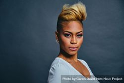 Portrait of proud Black woman with short blonde hair against gray background with copy space 4BnKM4