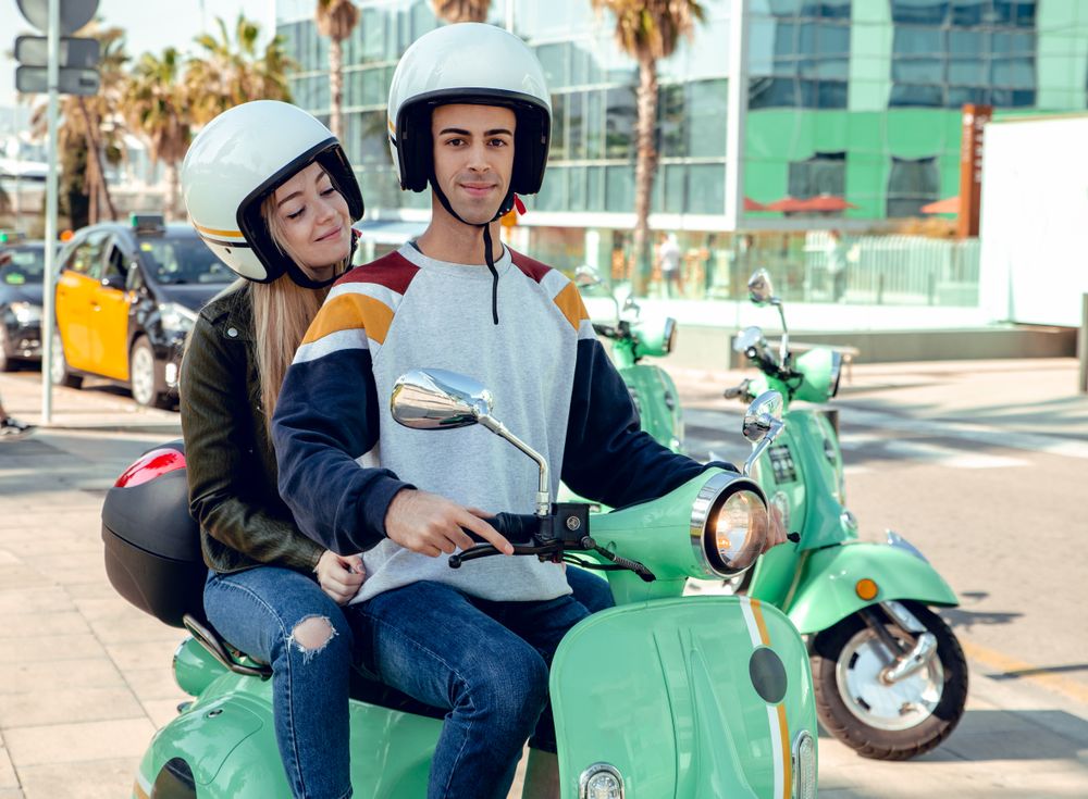 Couple sitting on scooter and talking