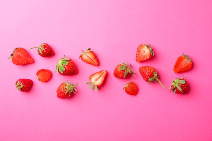 Flat lay composition with strawberries on color background, space for text. Summer sweet fruits and berries