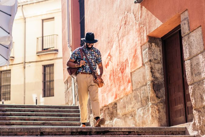 Stylish Black man walking on the city street