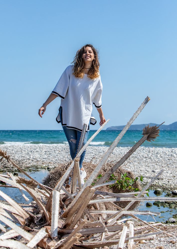 Young woman walking near dried plants