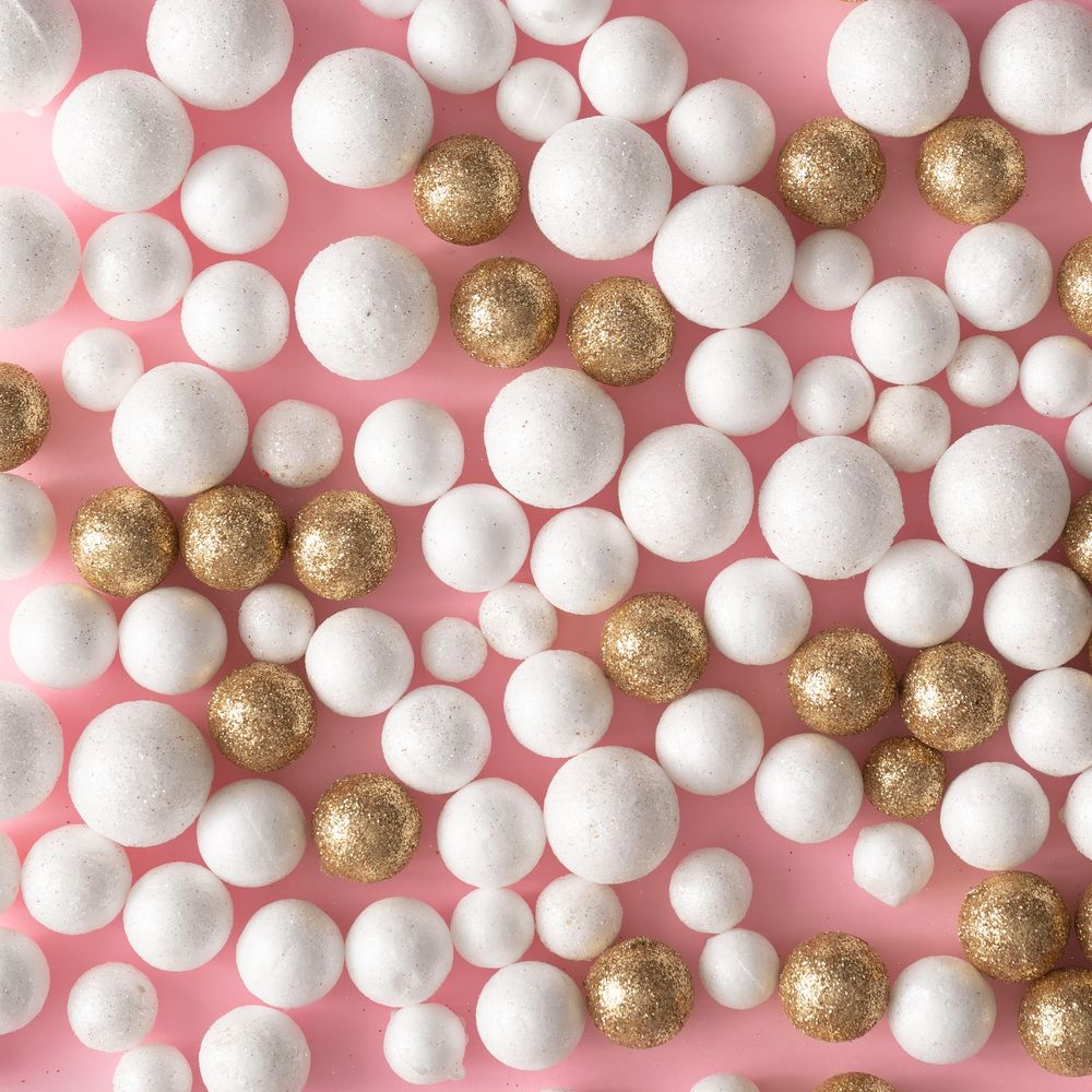 Christmas pink background made of gold and glitter ball decoration