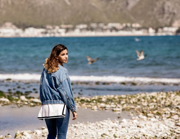 Young woman walking on seashore