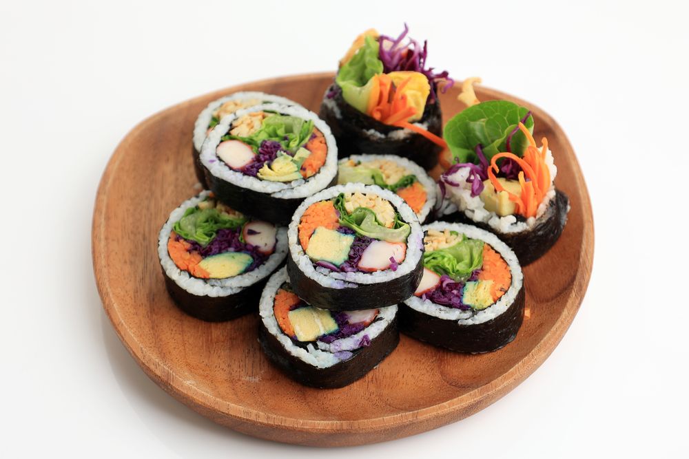 Kimbap, Korean Roll Rice with Nori Laver, Egg, Crab Stick, Carrot, Lettuce, and Purple Cabbage