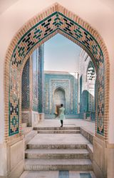 Woman walking in old archway