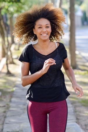 Happy woman jogging outside