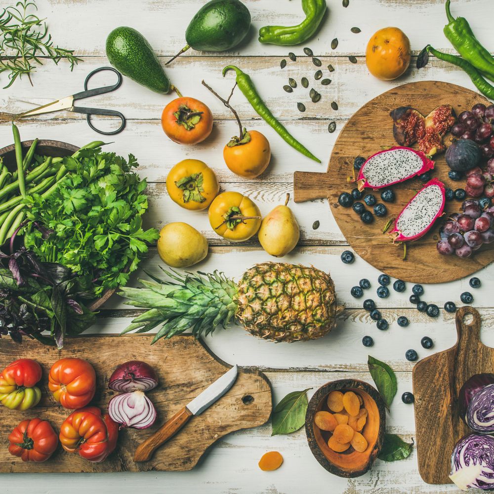 Top view of raw tropical fruits, vegetables, and herbs