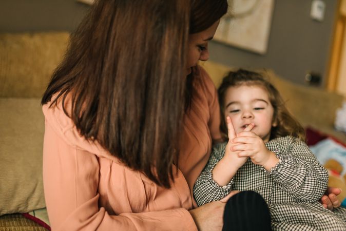 Woman hugging smiling daughter