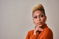 Studio shot of thoughtful Black woman with short blonde hair