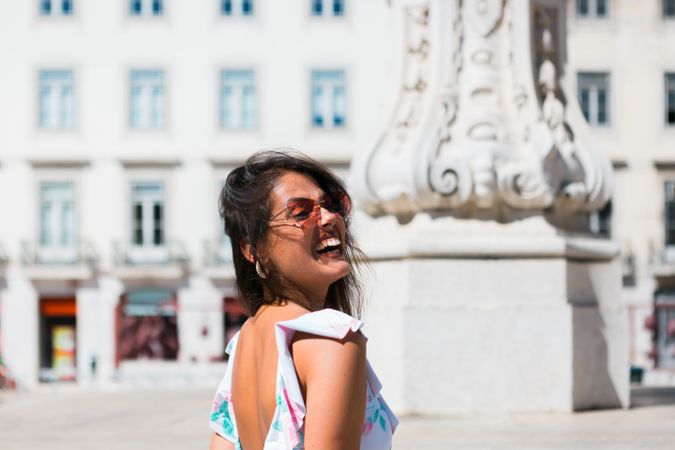 stylish woman in sunglasses sitting in street stairs