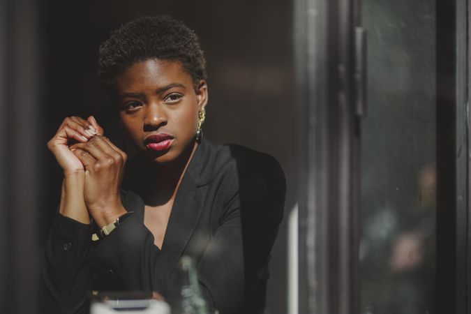 Smiling stylish Black woman in cafe