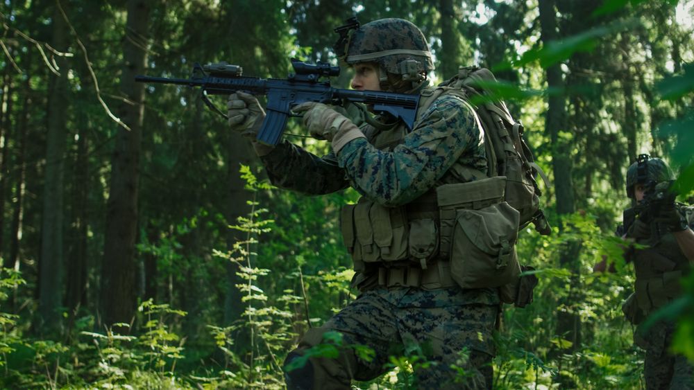 Squad of Fully Equipped Soldiers in Camouflage on a Reconnaissance Military Mission