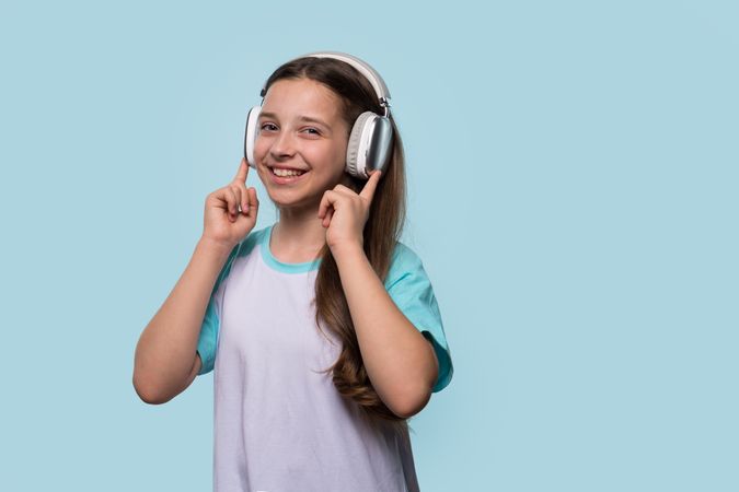Smiling girl enjoying music with headphones