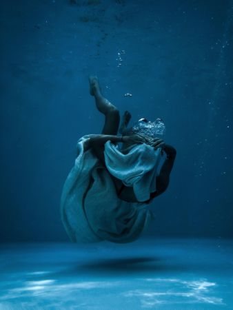 Underwater shot of person with light textile