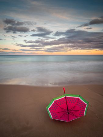 Umbrella on beach near sea