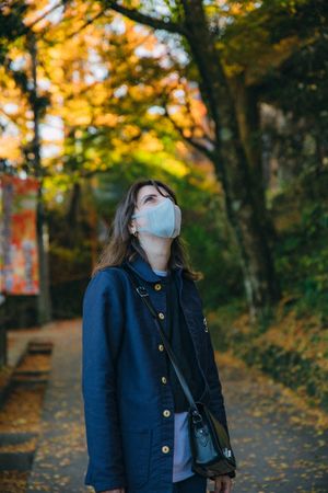 Woman with facemask in Takao Mountain near Tokyo, Japan