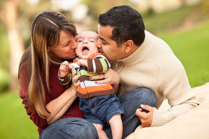 Happy Parents Playing with Their Son