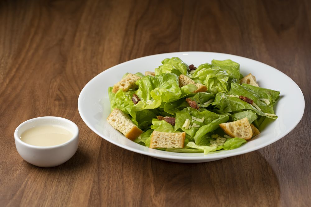 Caesar salad with croutons and bacon.